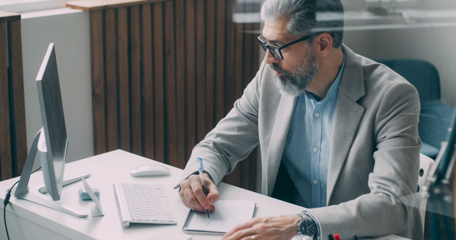 Man writing down health questions and notes Man writing down health questions and notes before a medical appointment